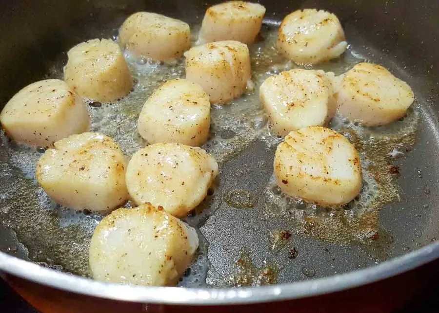 scallops cooking in a pan