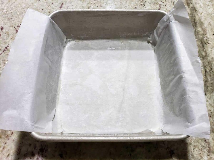 a parchment paper sling placed in a cake pan