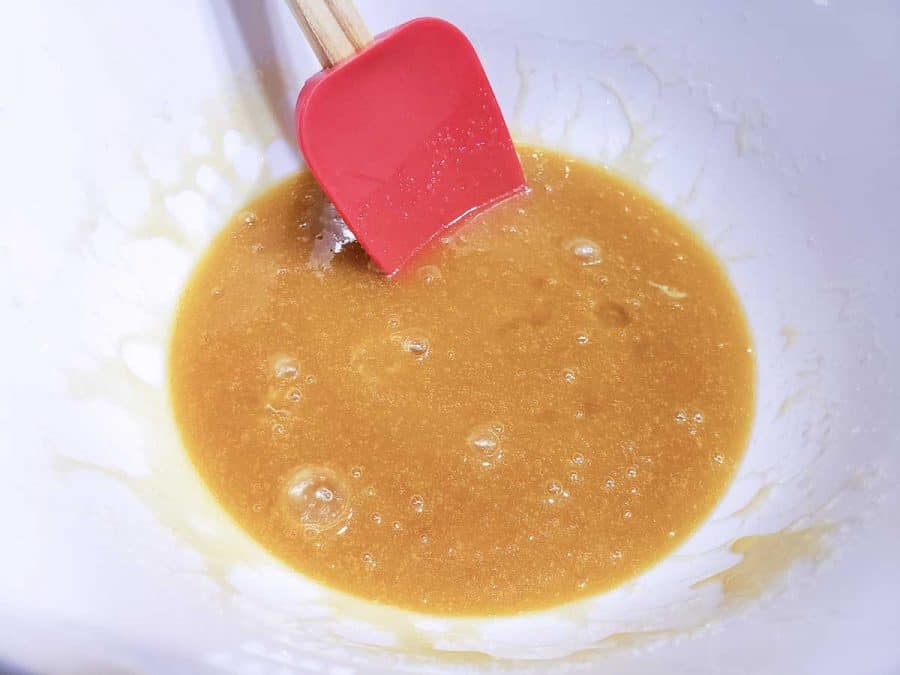 eggs and vanilla mixed into the butter mixture in a bowl