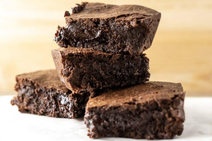 4 chewy fudge brownies stacked in a pile