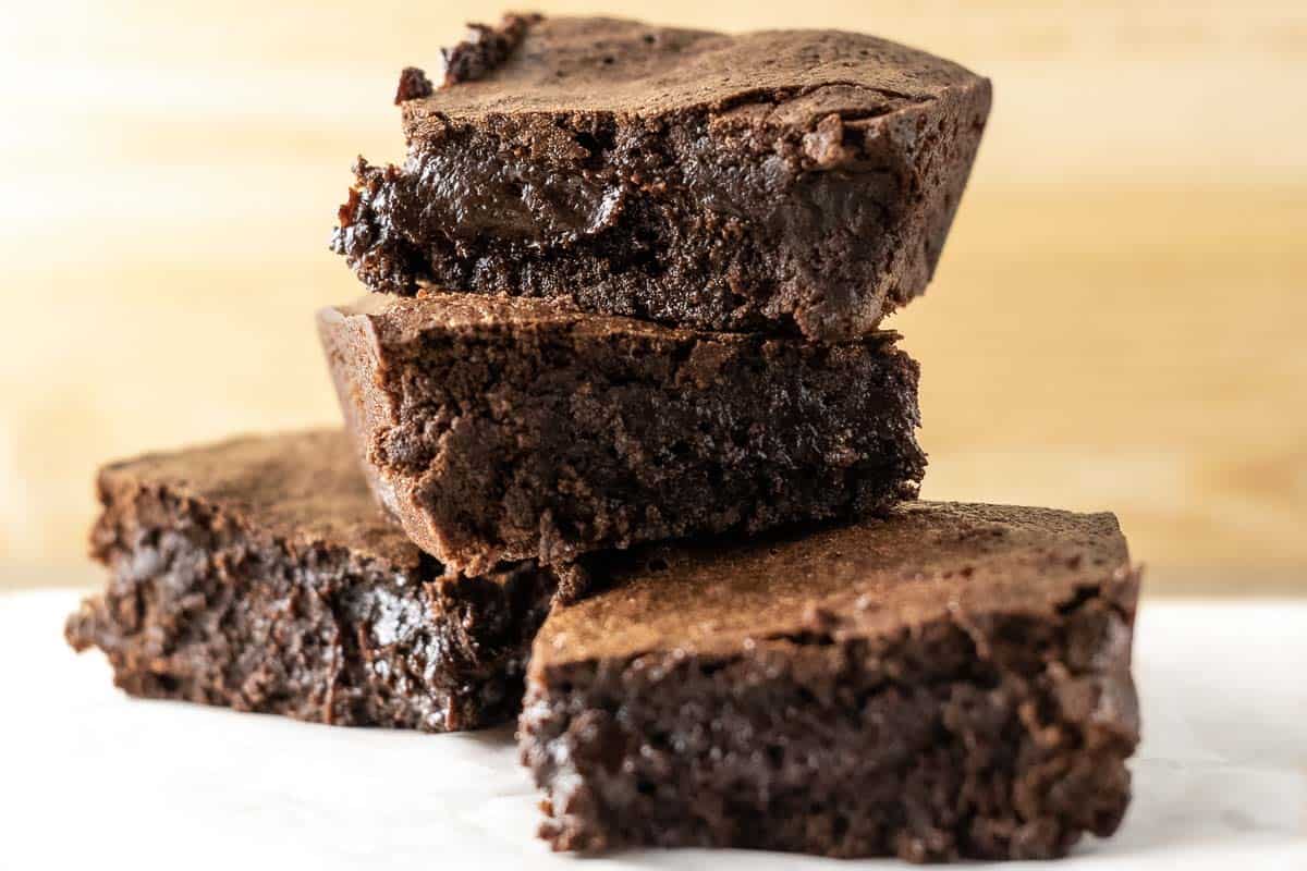 4 chewy Fudgiest Brownies Ever stacked in a pile.