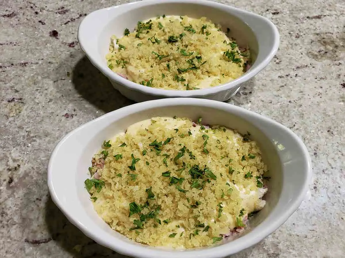 bread crumb mixture and parsley sprinkle over Chicken Swiss Cheese Casserole in casserole dishes.