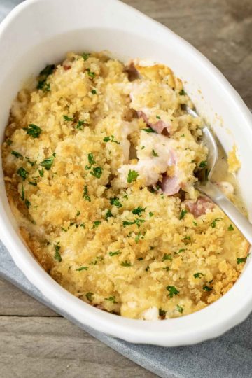 Low-carb Chicken Cordon Bleu Casserole close-up top down view with spoon digging into casserole