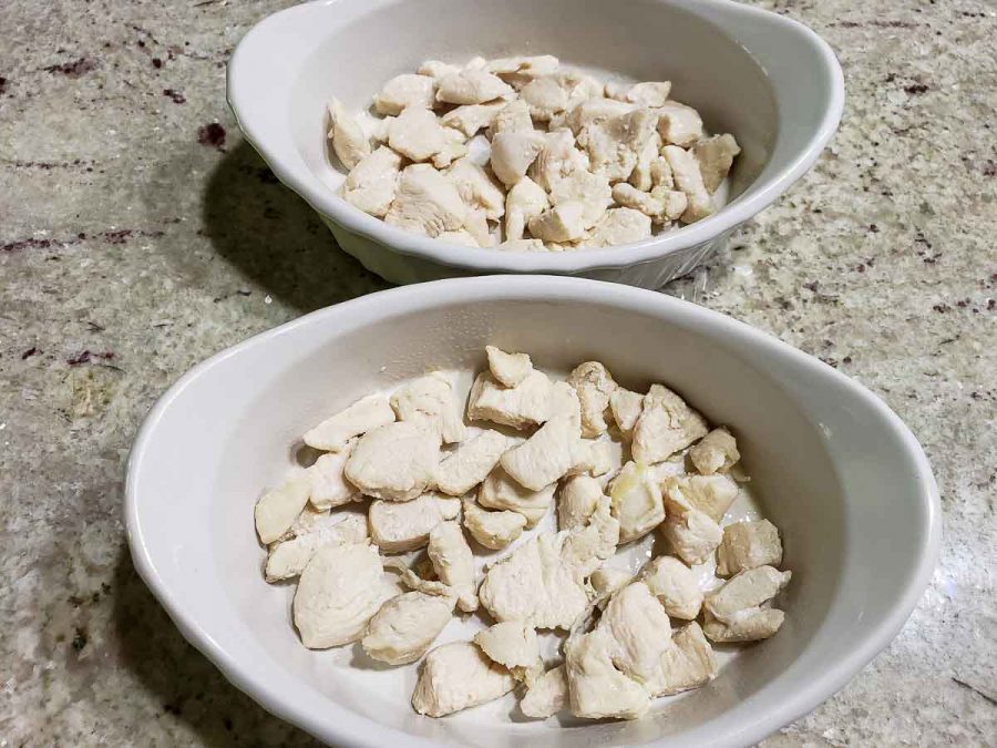 diced cooked chicken in two baking dishes