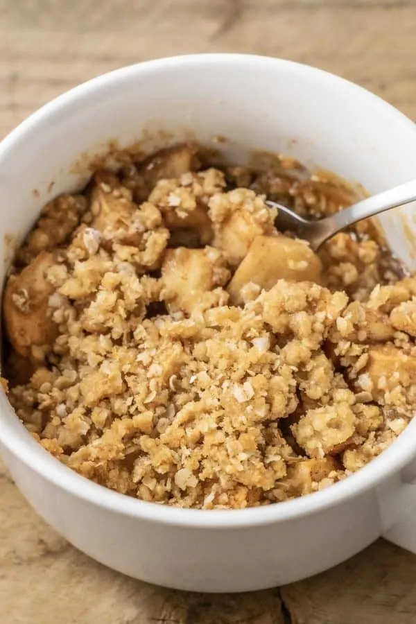 best Salted Caramel Apple Crisp top down view with a spoon.