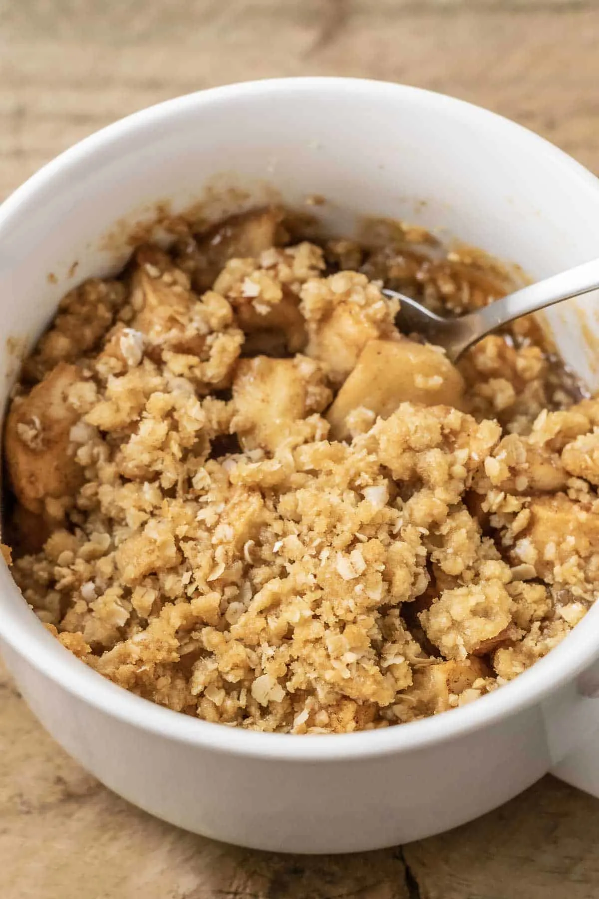 best Salted Caramel Apple Crisp top down view with a spoon