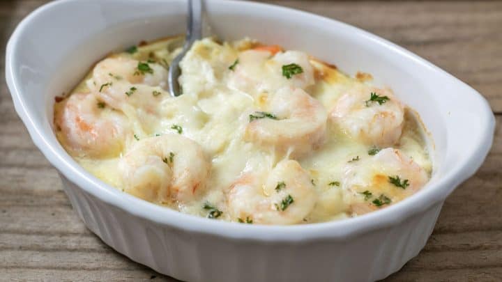 close up front view of Shrimp Scampi Pasta Bake in a dish with a spoon
