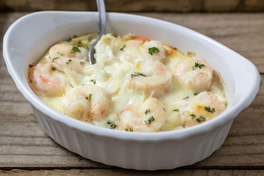 close up front view of easy Shrimp Scampi Pasta Bake in a casserole dish with a spoon