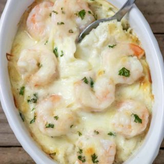 close up top down view of Shrimp Scampi Pasta Bake in a dish with a spoon