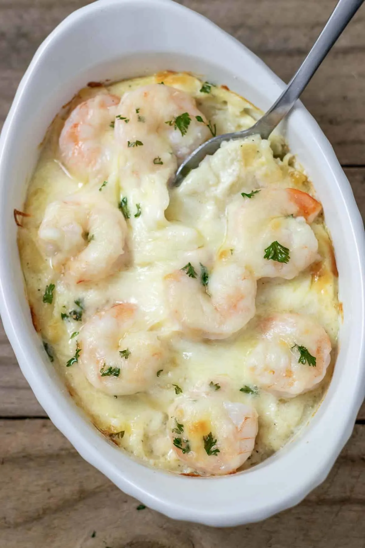 close up top down view of Shrimp Scampi Pasta Bake in a dish with a spoon