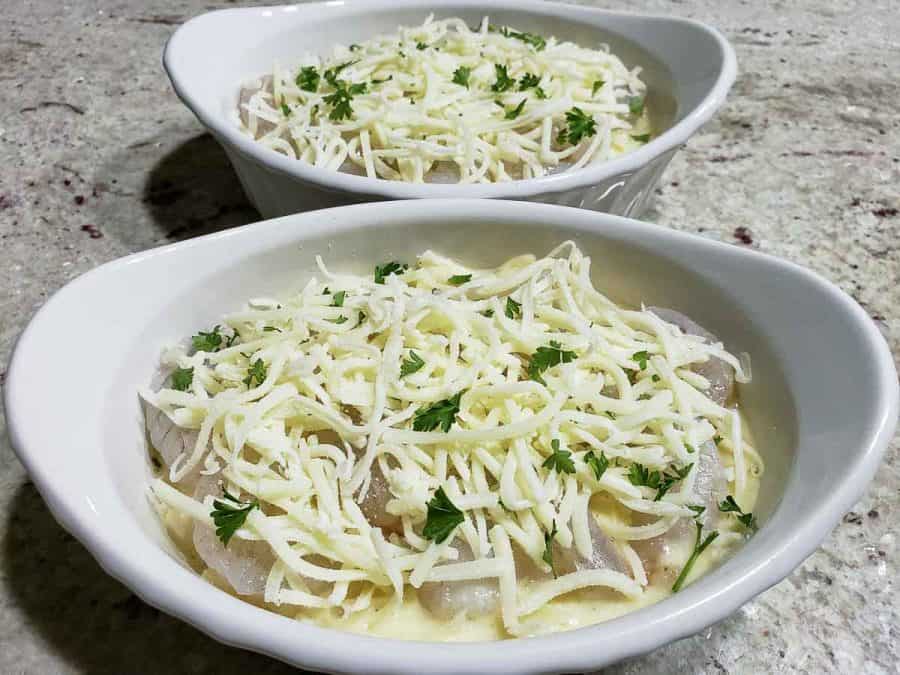 parsley sprinkled over cheese in two baking dishes