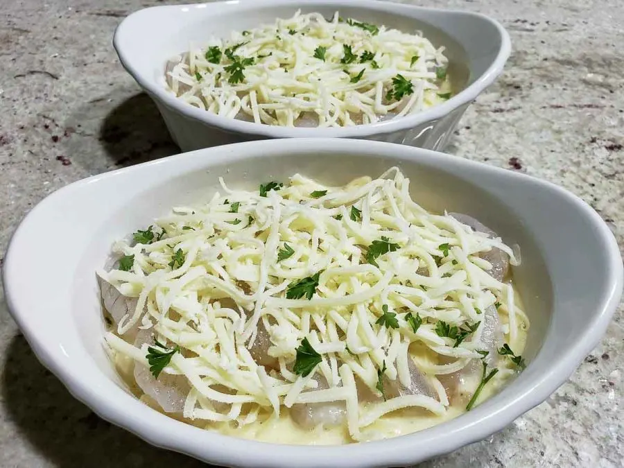 parsley sprinkled over cheese in two baking dishes