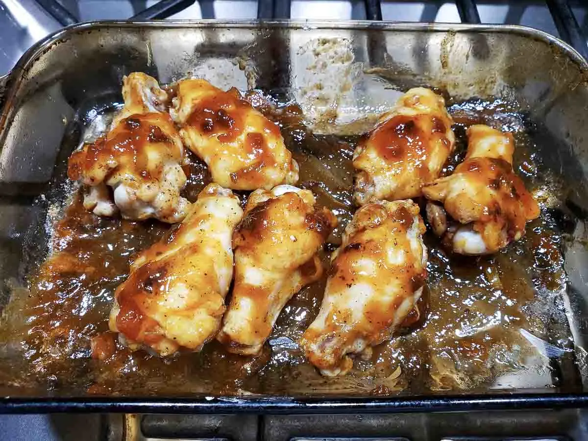 saucy wings in a baking dish.