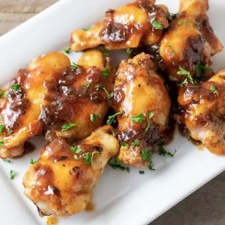 close up top down view of Sweet and Sour Sticky Wings on a white dish