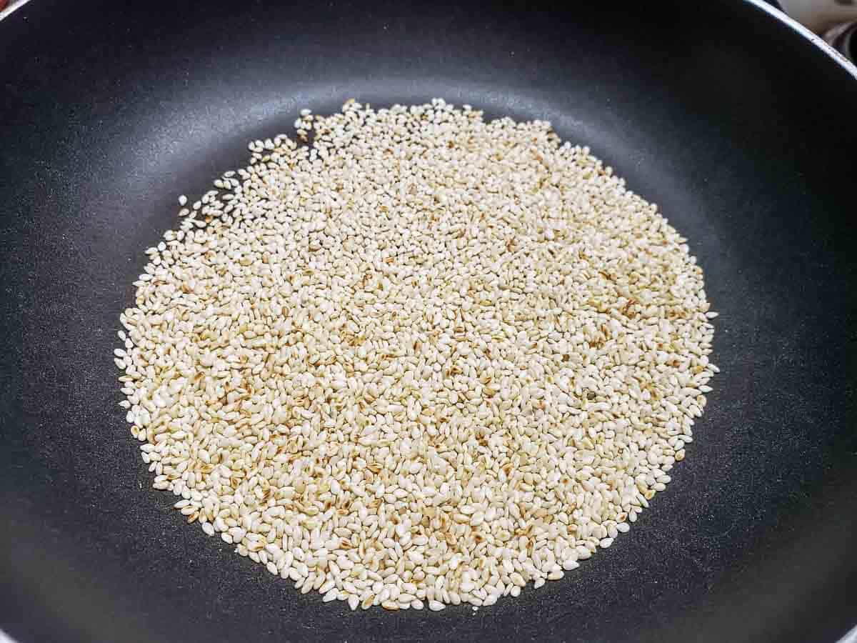 sesame seeds toasting in a dry frying pan.