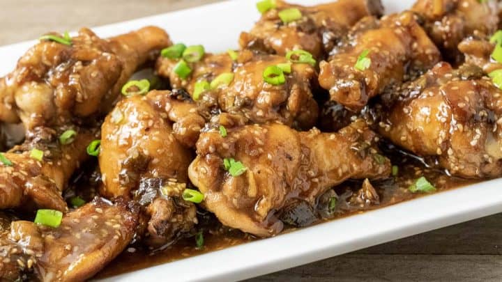 close up front view of Baked Asian Sticky Chicken Wings on a white platter