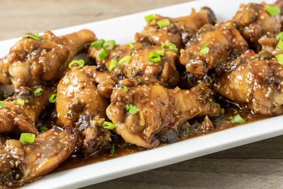 close up front view of Baked Asian Sticky Chicken Wings on a white platter