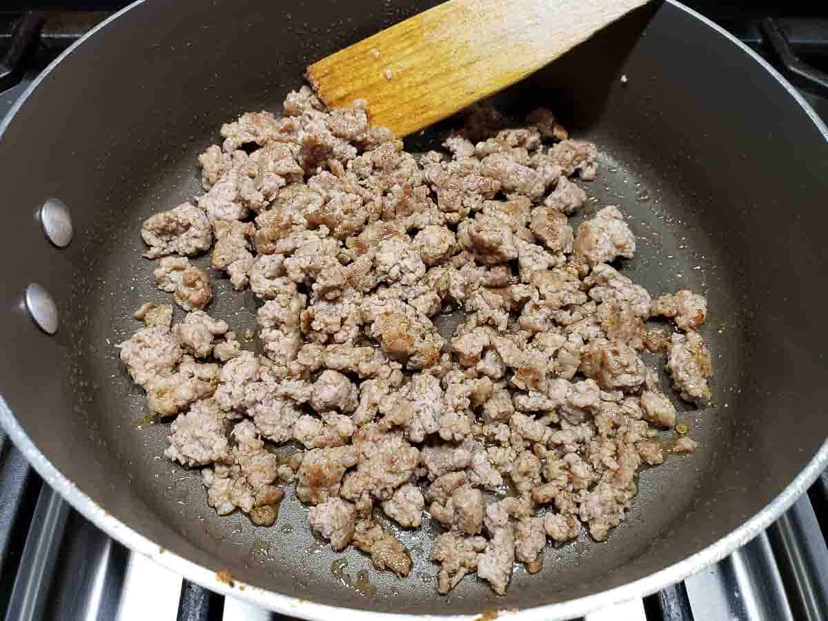 ground pork sausage cooking in a frying pan