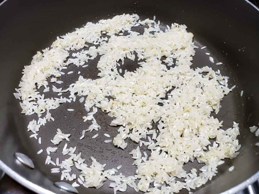 rice coated in butter in a pan