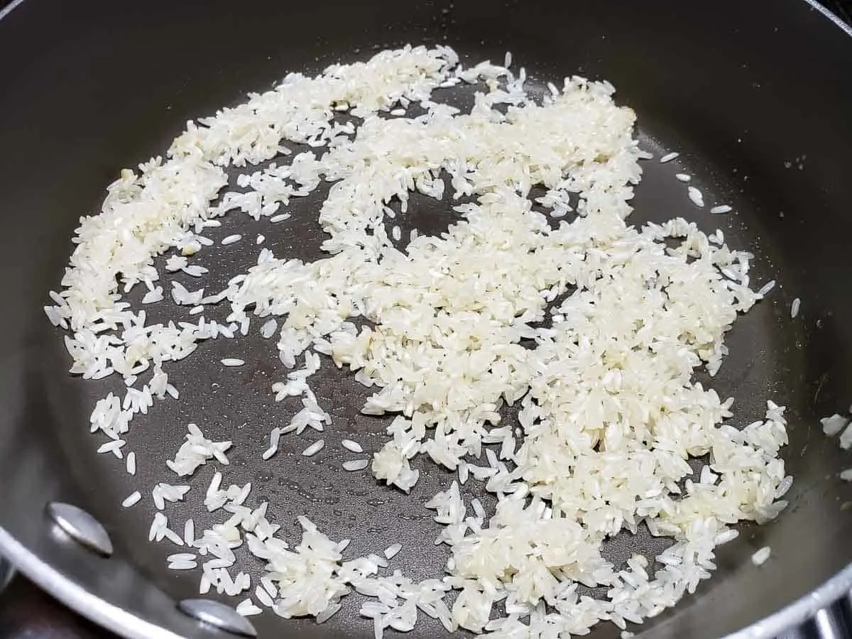 rice coated in butter in a pan.