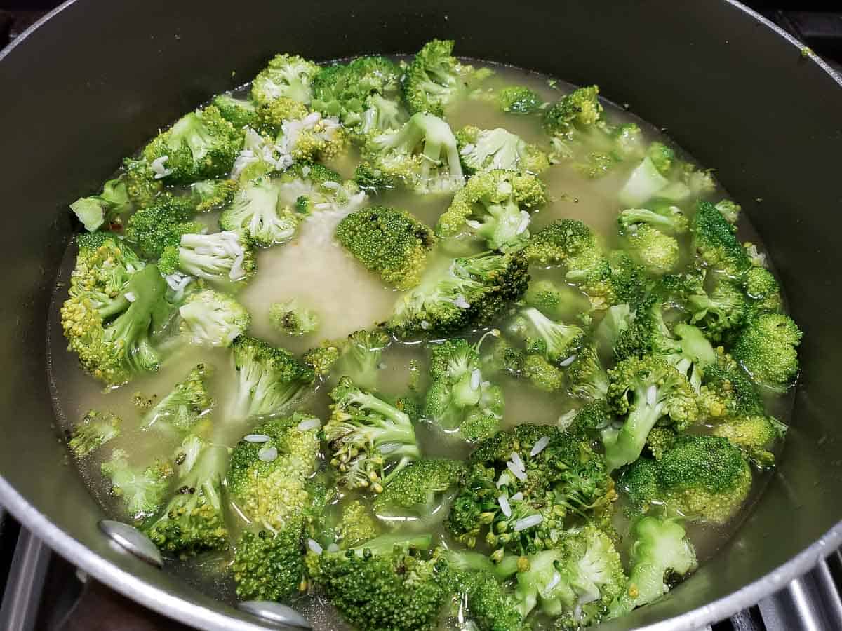 broccoli and rice cooking in chicken stock.