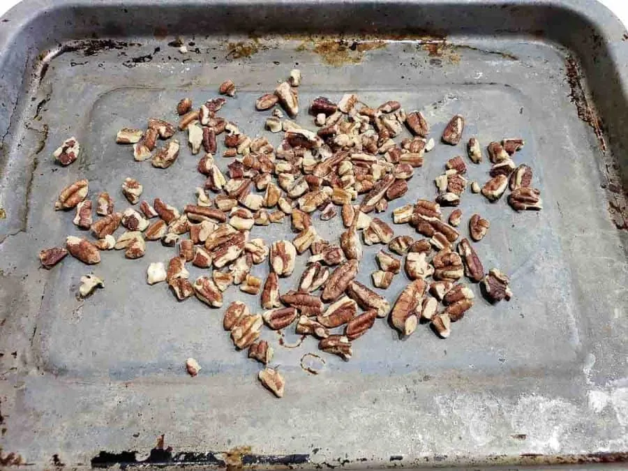 chopped pecans on a baking sheet.