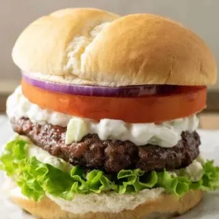 a big fat greek feta cheese burger on parchment paper