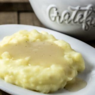 easy chicken gravy from scratch poured over mashed potatoes