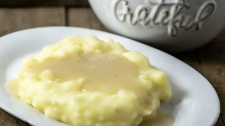 easy chicken gravy from scratch poured over mashed potatoes