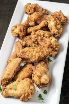 Deep Fried Crispy Chicken Wings on a white platter