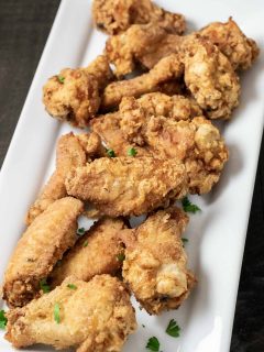 Deep Fried Crispy Chicken Wings on a white platter