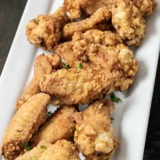 Deep Fried Crispy Chicken Wings on a white platter