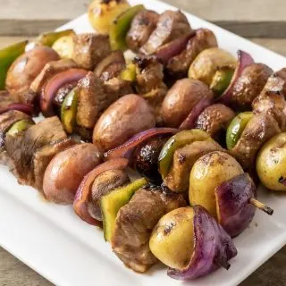 4 Easy Marinated Grilled Steak Kabobs on a square white plate