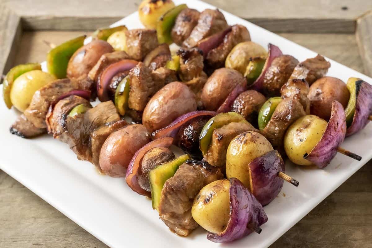 4 Easy Marinated Grilled Steak Kabobs on a square white plate