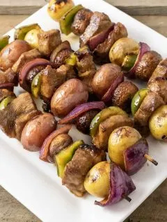 Four Easy Marinated Grilled Steak Kabobs on a platter