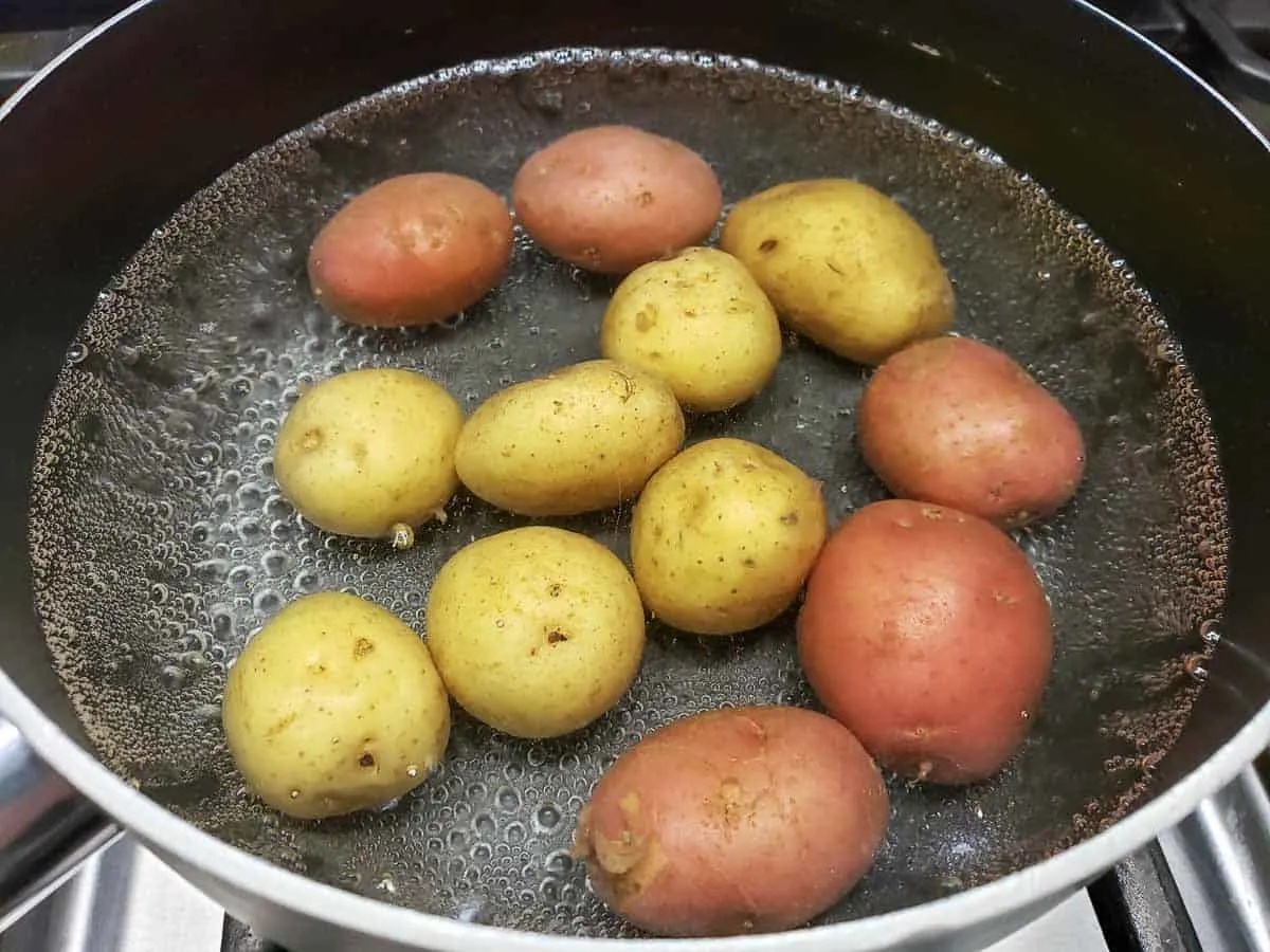 12 baby potatoes cooking in a pan