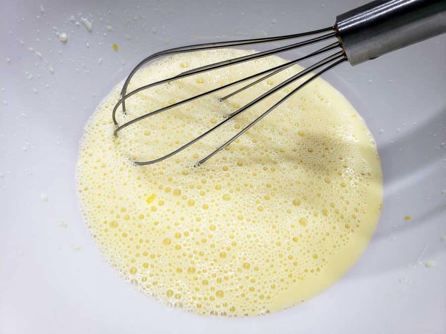 homemade buttermilk and egg whisked in a bowl
