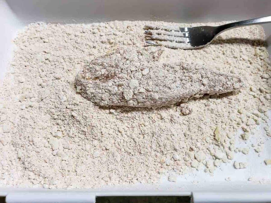 a chicken finger coated in flour and seasonings