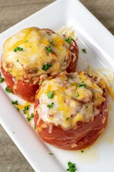 Two Slow Cooker Stuffed Peppers on a white platter