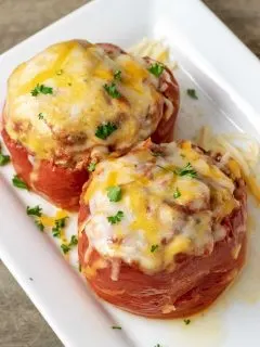 Two Slow Cooker Stuffed Peppers on a white platter