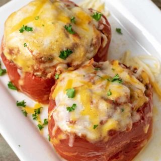 Two Slow Cooker Stuffed Peppers on a white platter