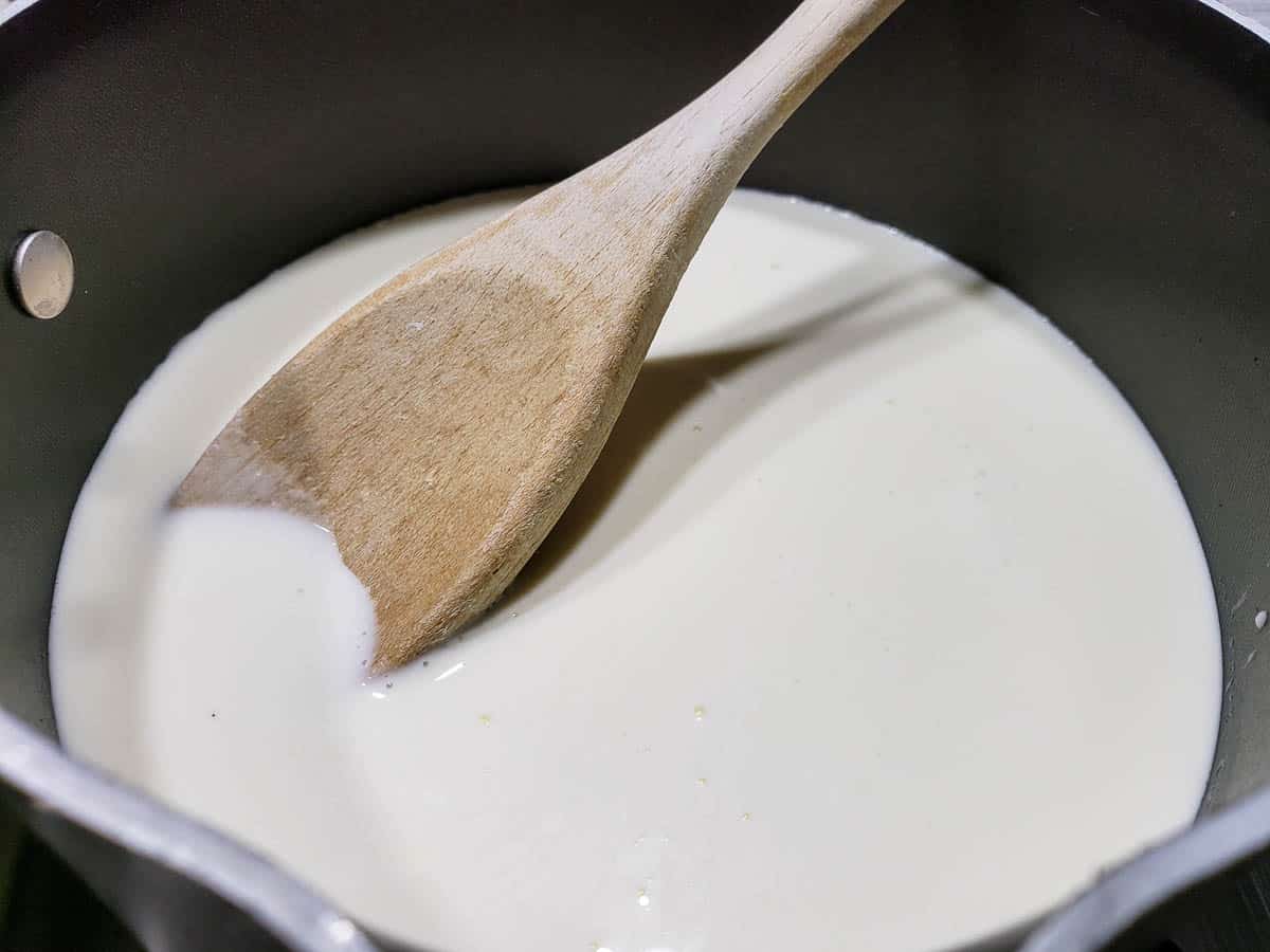 heavy cream cooking in a pan.