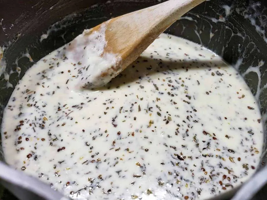 Parmesan and basil sauce cooking in a pan