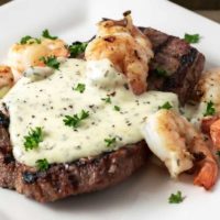 Applebees Steak and Shrimp Parmesan on a plate.