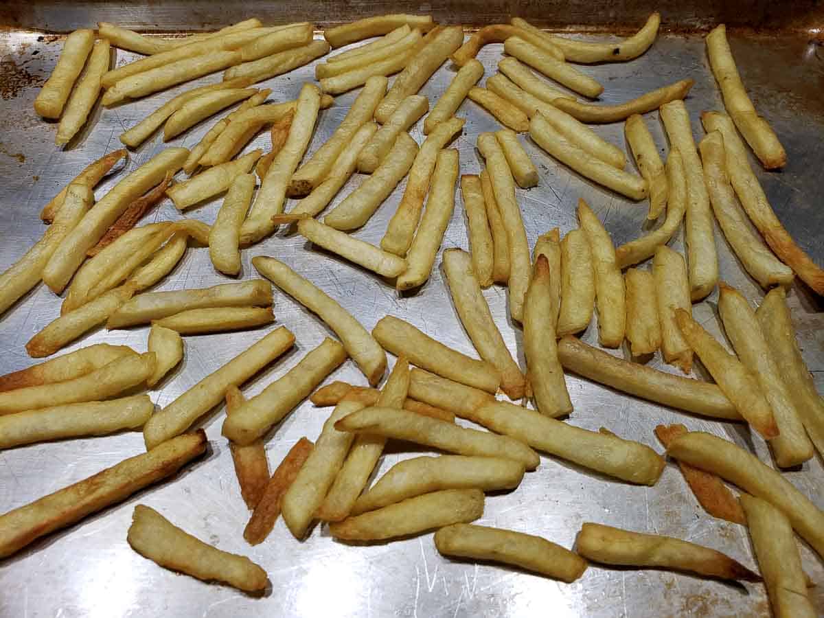 baked French fries on a baking sheet