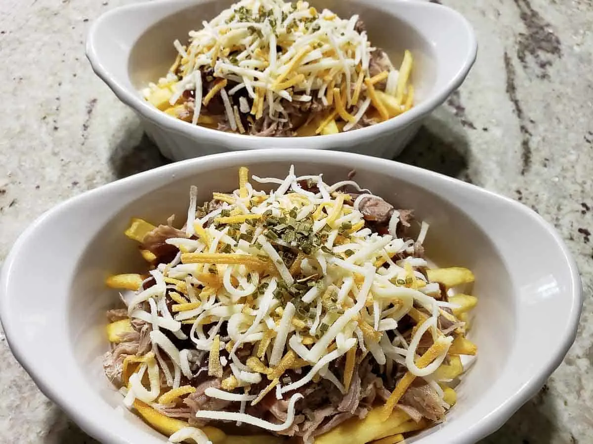 loaded pig fries in two casserole baking dishes