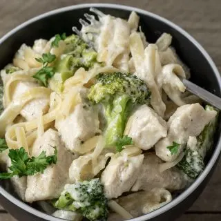 a bowl filled with Chicken Fettuccine Alfredo with Broccoli.