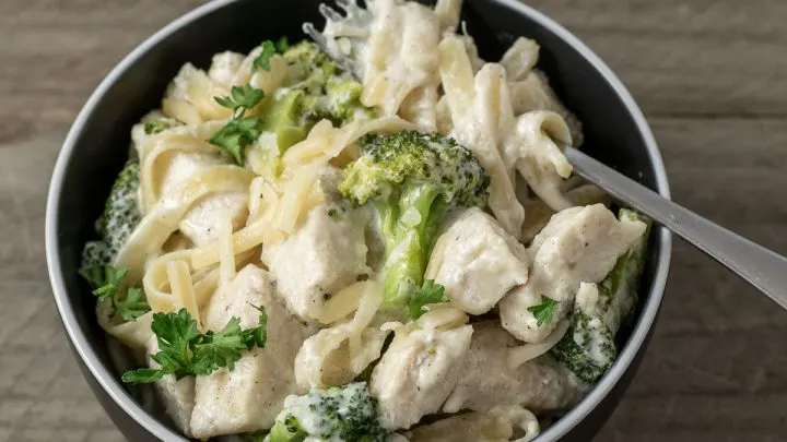 a bowl filled with Chicken Fettuccine Alfredo with Broccoli