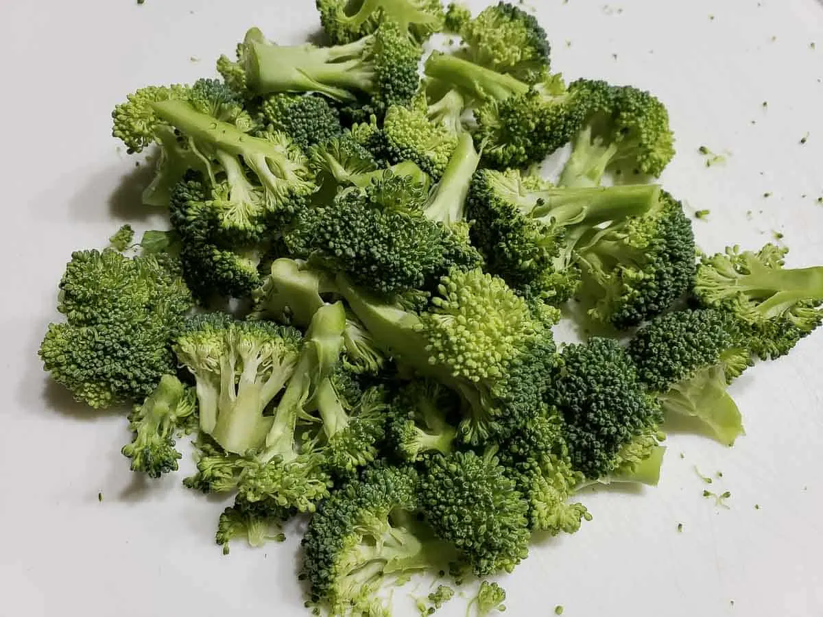 chopped broccoli on a cutting board.