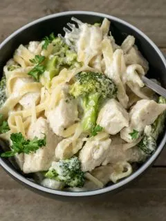Chicken Fettuccine Alfredo with Broccoli in a bowl with a fork.